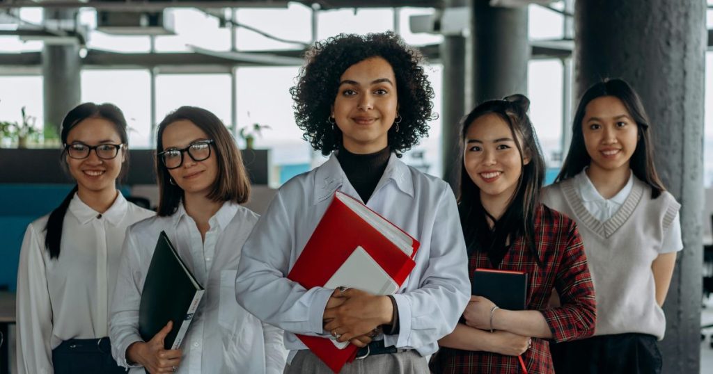 Group of diverse female students in a modern study environment, symbolizing empowerment and academic excellence through the Hatfield Lioness Scholarship.