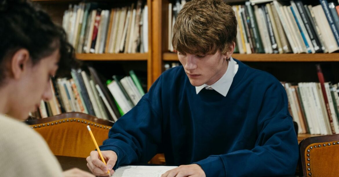 Research School of Management Master of Business Administration Scholarship Two students studying in a library, preparing for their Master of Business Administration (MBA) scholarship application.